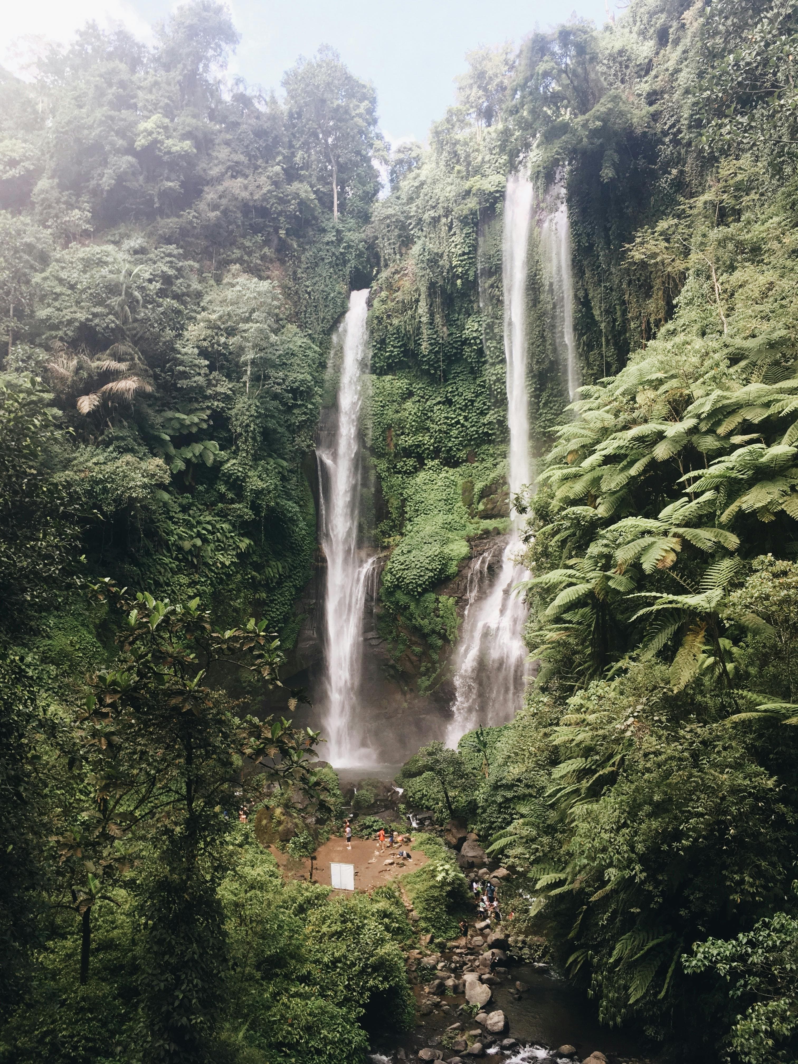 ekumpul features multiple cascading falls surrounded by tropical jungle